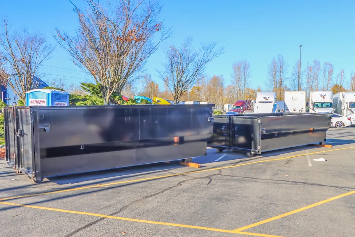 Professional dumpster rental service with roll-off container on residential driveway in Seabrook